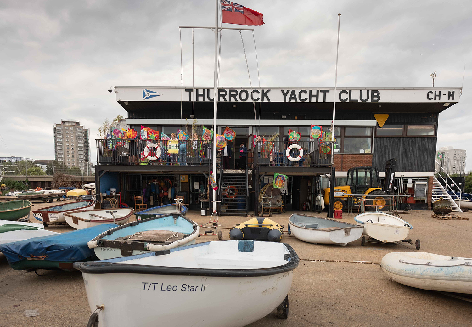 Outside view of Thurrock Yacht Club with landed sailing dinghies in the foreground
