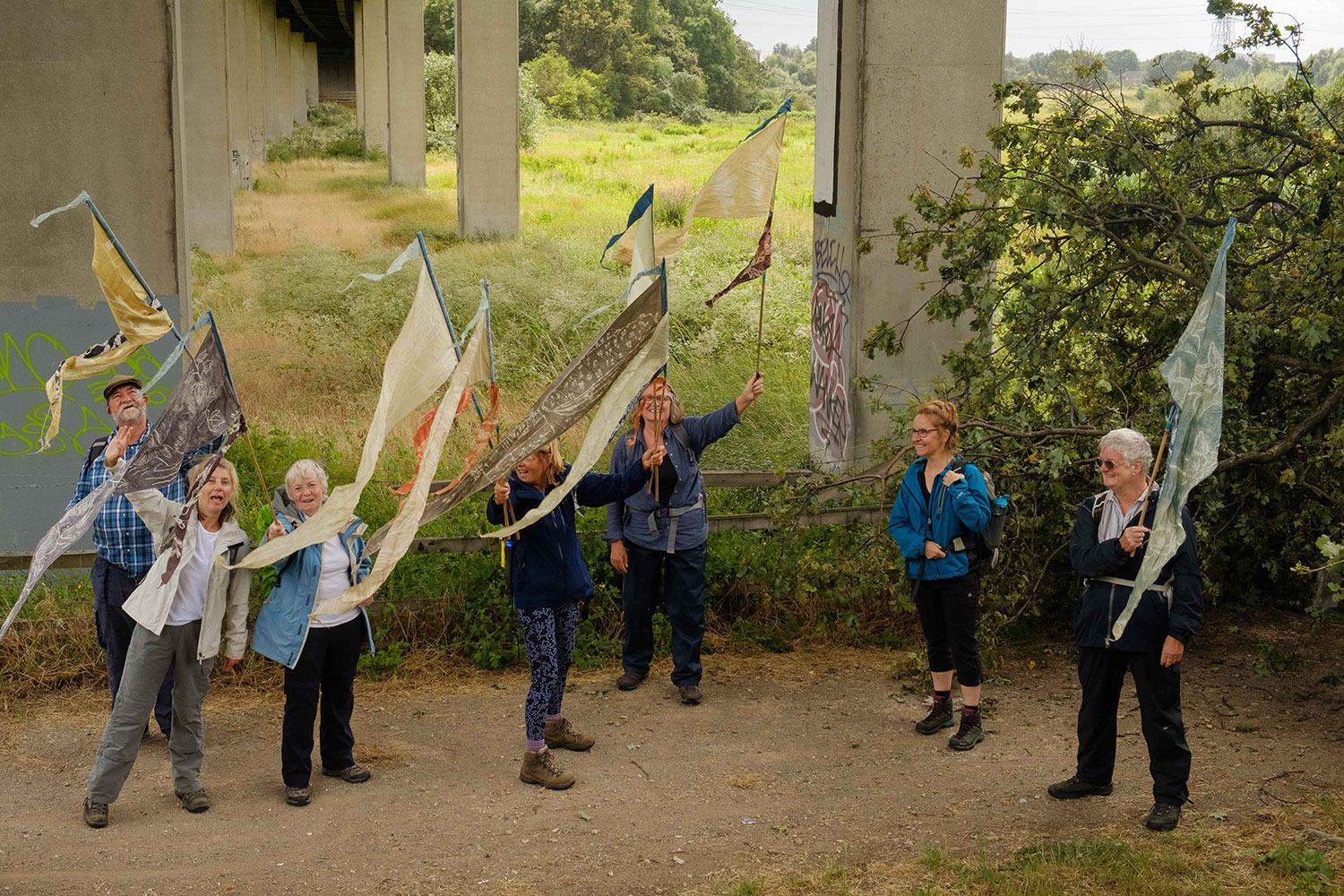 Purfleet walkers hold flags as they smile at the camera for a group photo