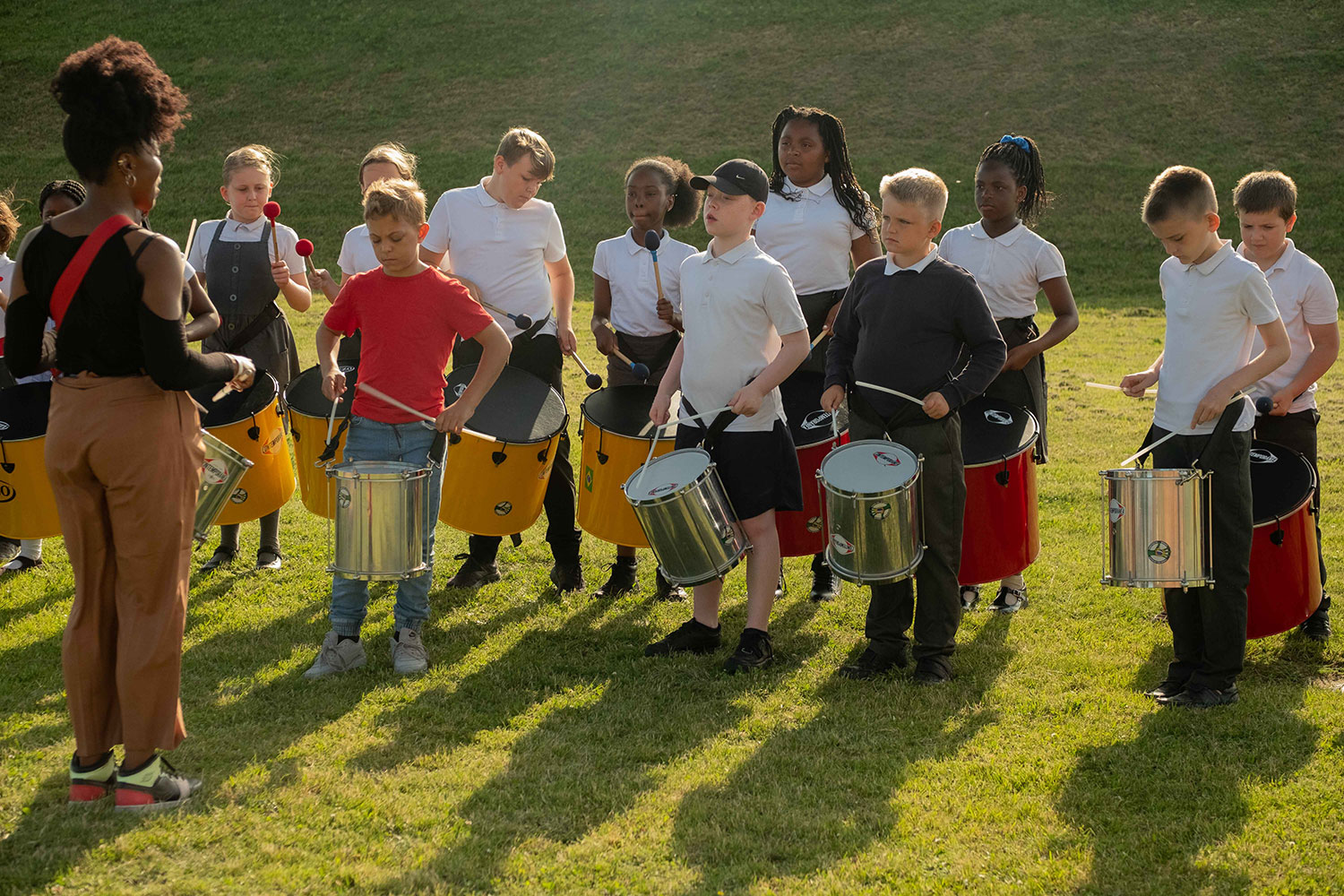 Young musicians play samba drums with Kinetika Bloco at Tilbury Fort